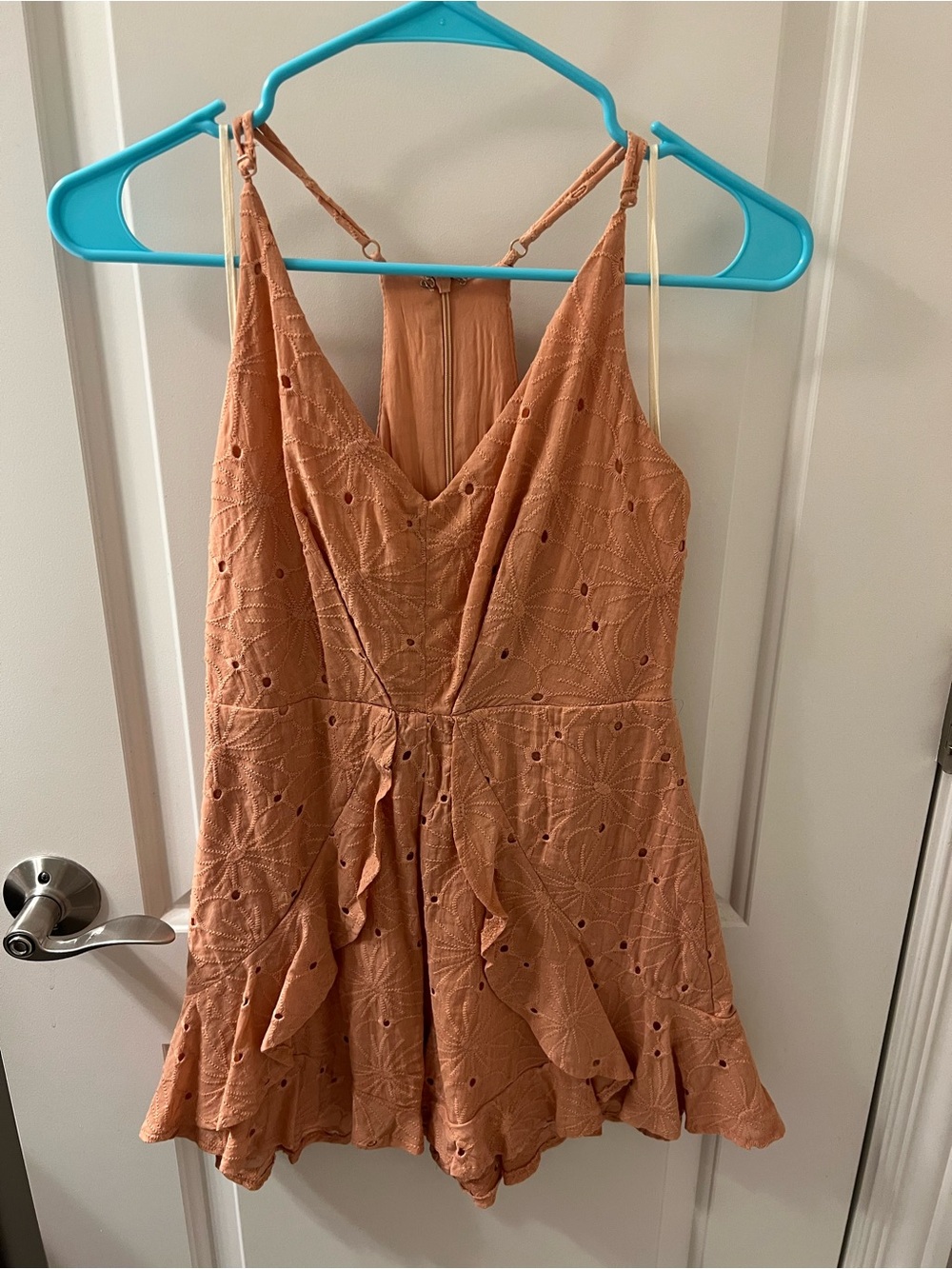 mahina Peach Eyelet Romper with V-Neck and Ruffle Hem